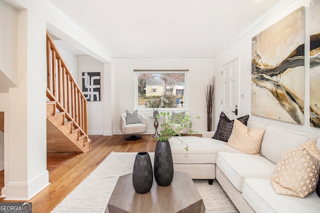 living room featuring ornamental molding and wood-type flooring