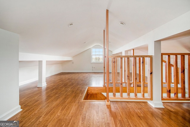 additional living space with lofted ceiling and wood-type flooring