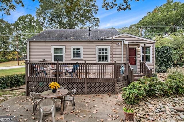 rear view of property with a patio and a wooden deck