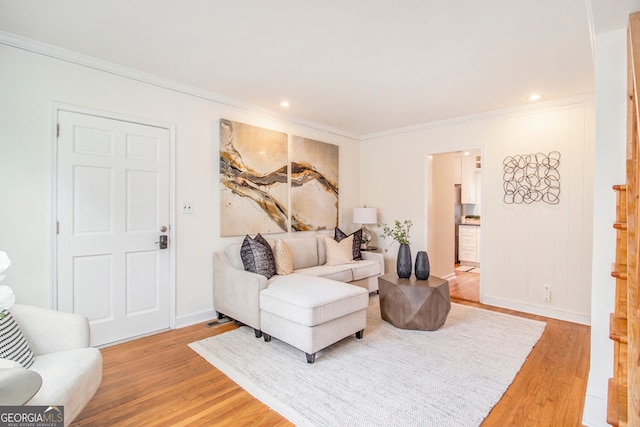 living room featuring wood-type flooring and crown molding