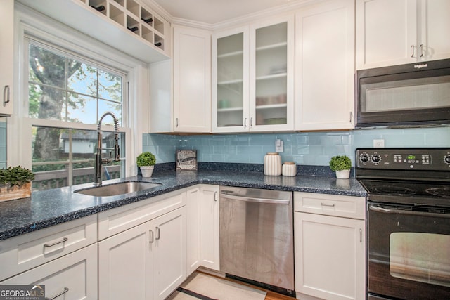 kitchen with sink, black appliances, dark stone counters, backsplash, and white cabinets