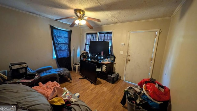 646 Straight St, Macon, GA 31204 - living room featuring ceiling fan, crown molding, wood-type flooring, and a textured ceiling