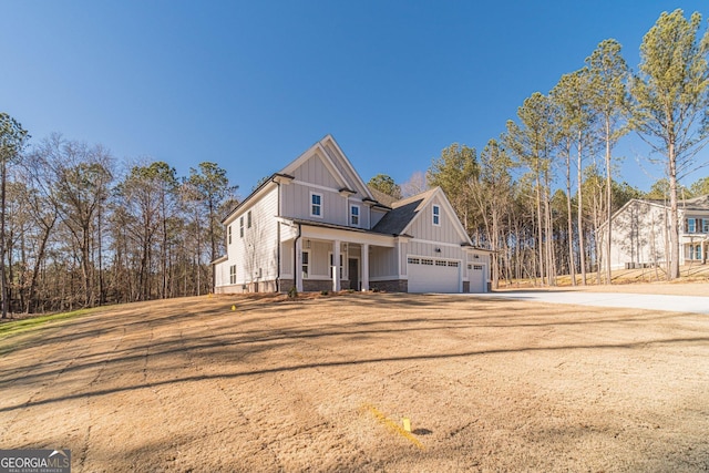 view of front of property featuring covered porch and a garage