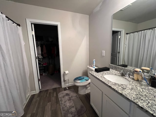 bathroom with vanity, toilet, and hardwood / wood-style floors