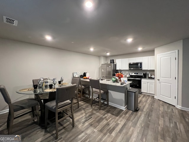 dining space with dark wood-type flooring