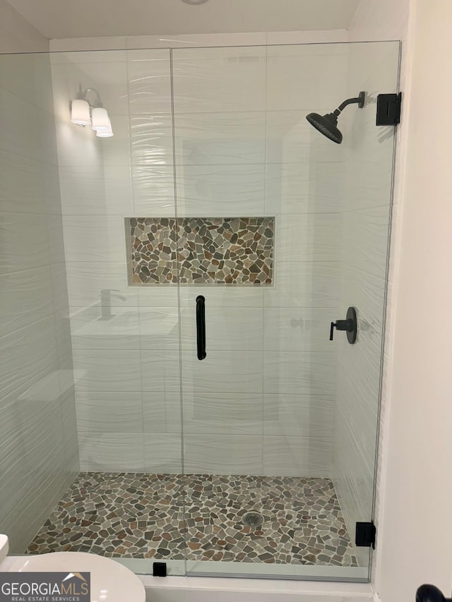 bathroom featuring toilet and walk in shower