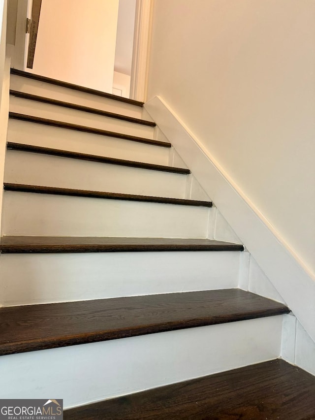 stairway featuring wood-type flooring