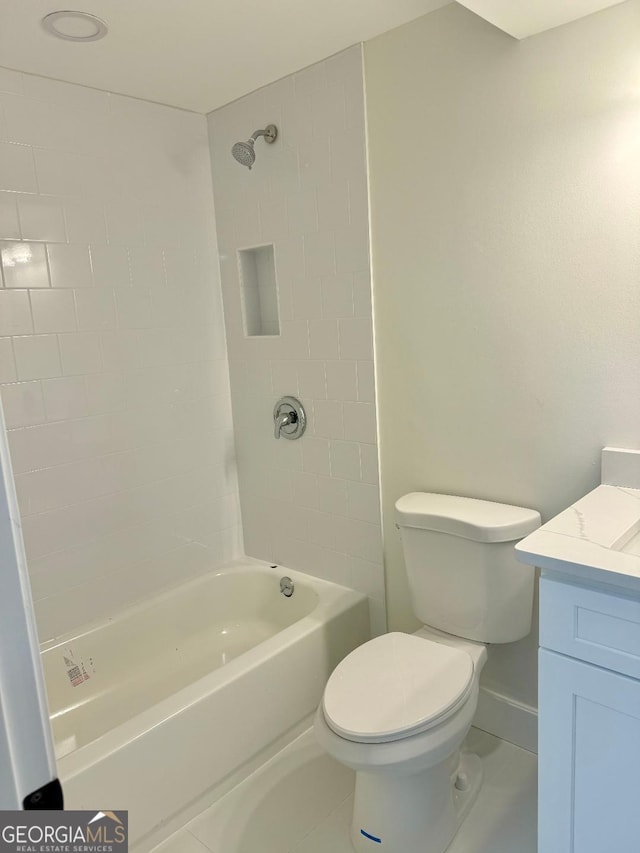 full bathroom featuring vanity, toilet, tiled shower / bath combo, and tile patterned flooring