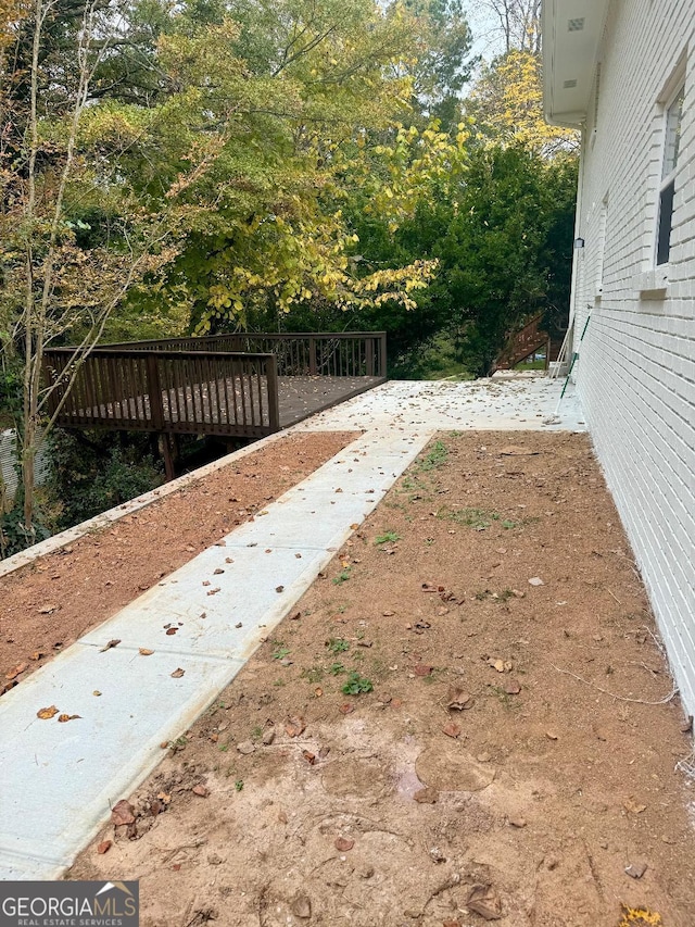 view of yard featuring a wooden deck