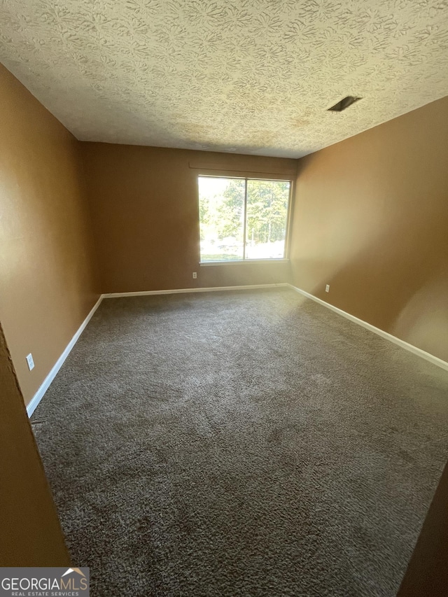8596 Creekwood Way, Jonesboro, GA 30238 - unfurnished room featuring a textured ceiling, baseboards, and carpet floors