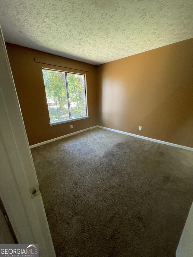 8596 Creekwood Way, Jonesboro, GA 30238 - empty room with a textured ceiling, baseboards, and carpet