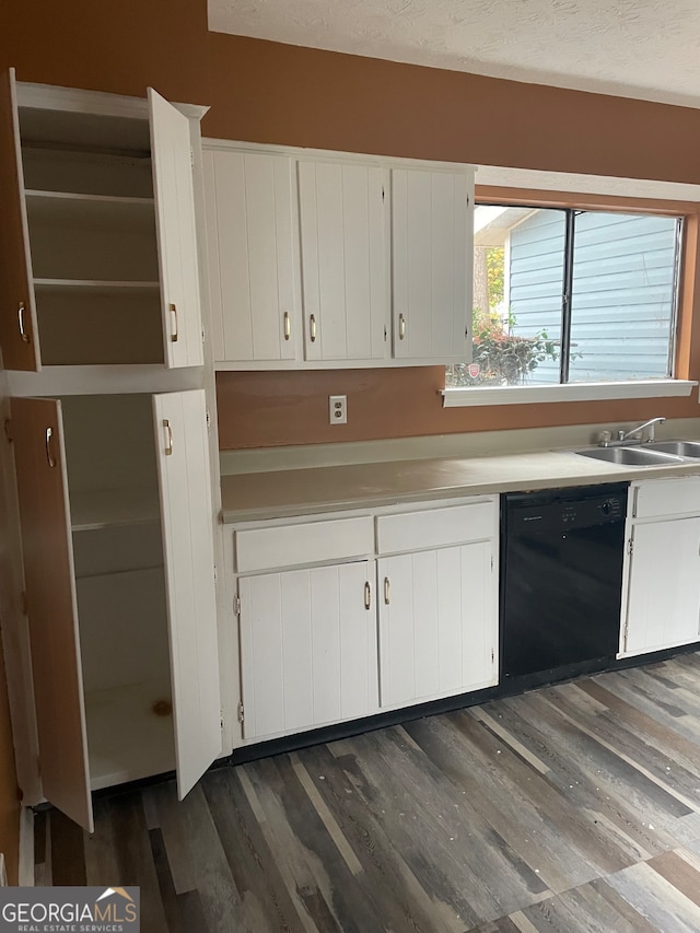 kitchen featuring black dishwasher, white cabinetry, dark hardwood / wood-style floors, and sink