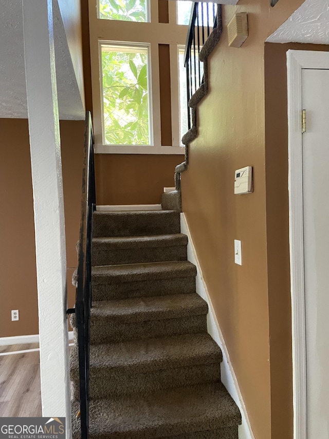 8596 Creekwood Way, Jonesboro, GA 30238 - staircase featuring wood finished floors and baseboards