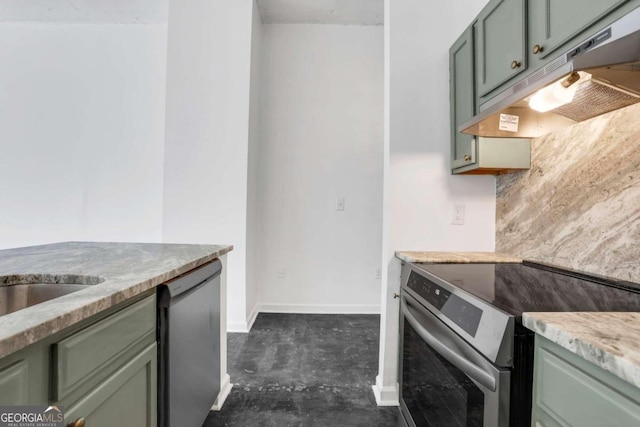 kitchen with green cabinetry, appliances with stainless steel finishes, and light stone counters