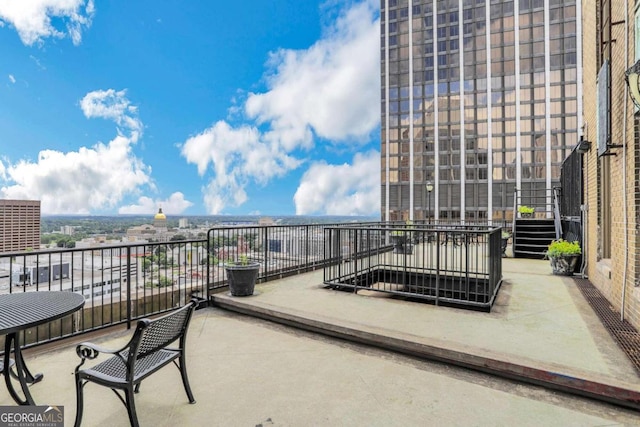 view of patio featuring a balcony