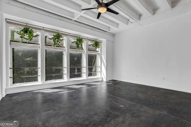 spare room featuring ceiling fan and beamed ceiling