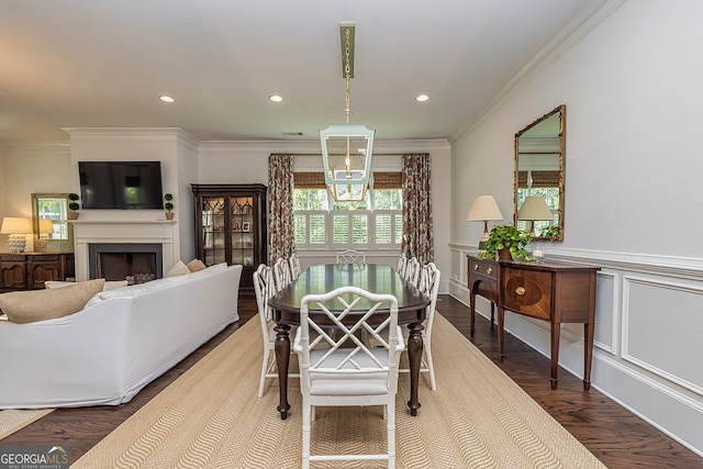 dining area featuring ornamental molding and hardwood / wood-style floors