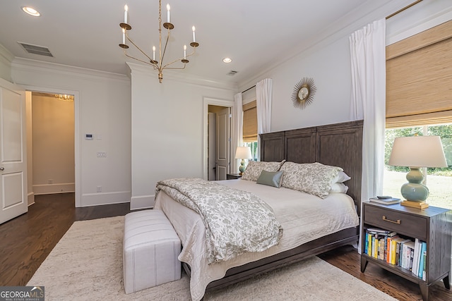 bedroom with crown molding, dark hardwood / wood-style floors, and a notable chandelier