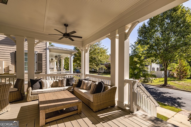 wooden terrace featuring a porch and ceiling fan