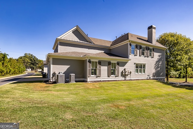 rear view of house featuring a lawn