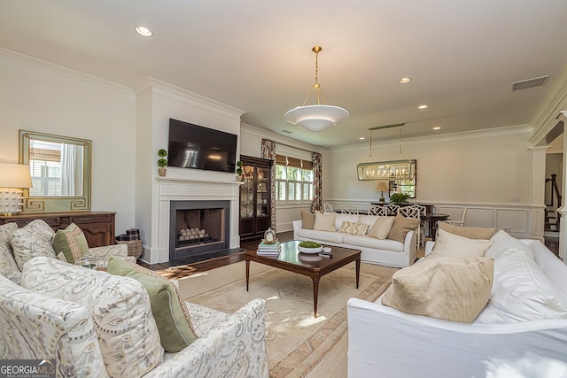 living room with crown molding and light hardwood / wood-style flooring