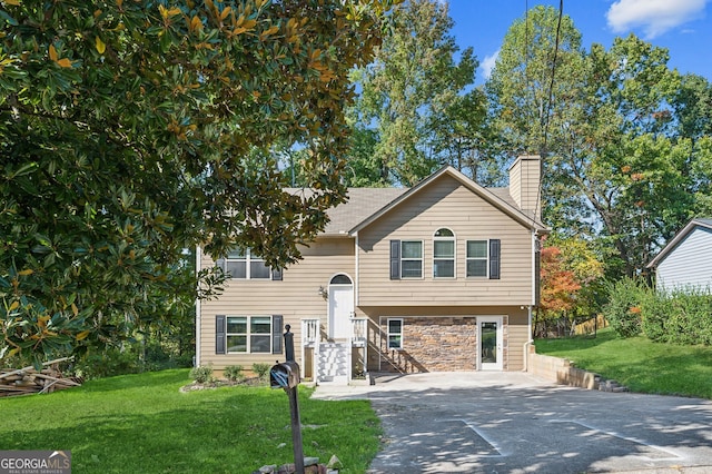 bi-level home with a front lawn