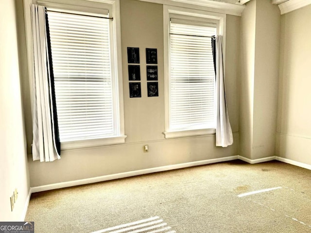 empty room with carpet floors and a healthy amount of sunlight