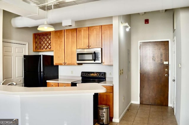 kitchen featuring decorative light fixtures, black appliances, and light tile patterned floors