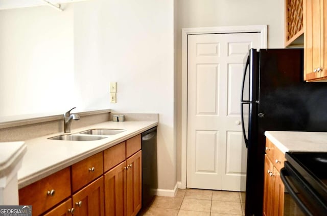 kitchen with sink, black appliances, and light tile patterned floors