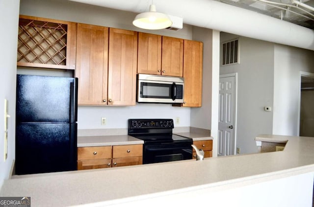 kitchen featuring decorative light fixtures and black appliances