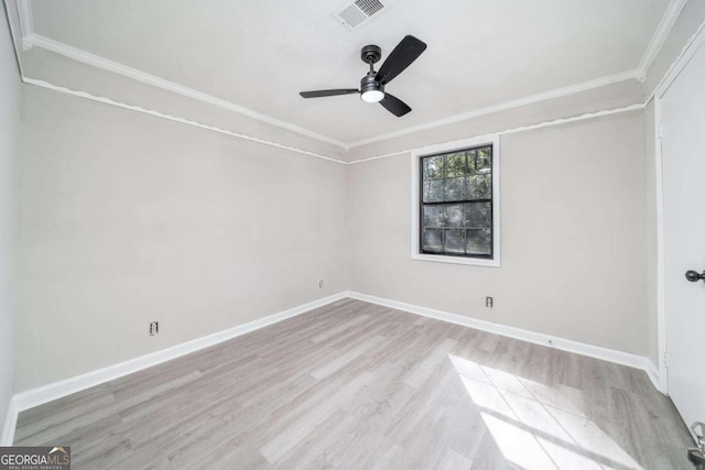 spare room featuring crown molding, light wood-type flooring, and ceiling fan