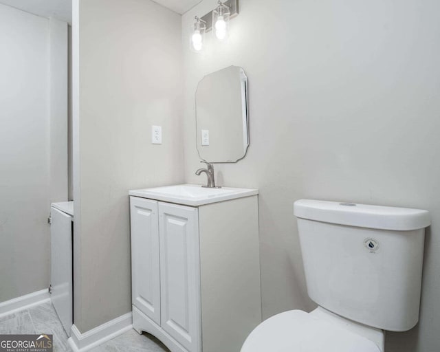 bathroom featuring toilet and vanity