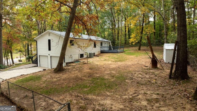 view of home's exterior with a garage and central AC unit