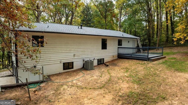 back of house with a deck and central AC unit