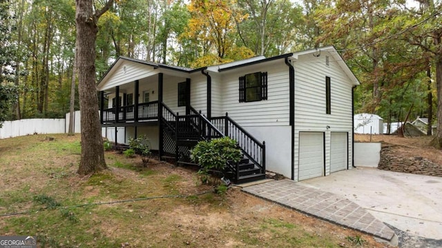 view of front of house featuring a porch and a garage