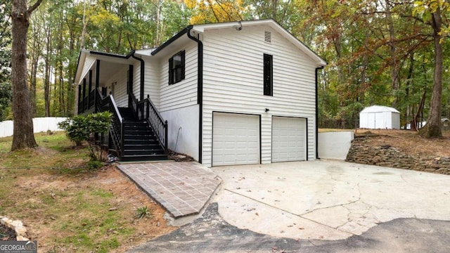 view of property exterior with a storage shed and a garage