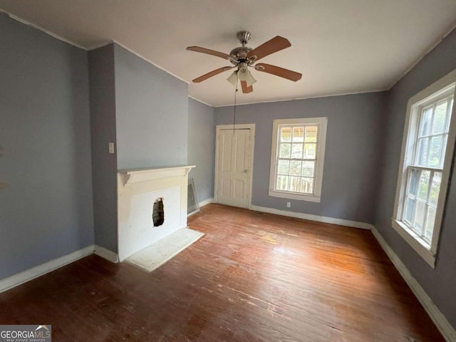 unfurnished living room with ceiling fan and hardwood / wood-style flooring