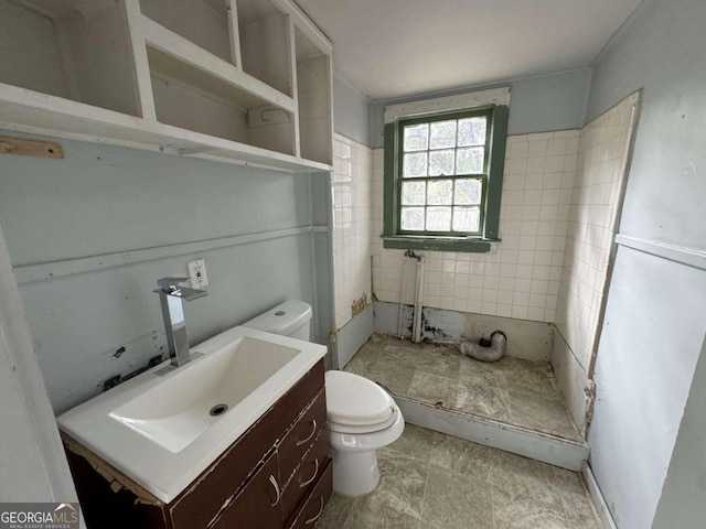 bathroom featuring vanity, toilet, and walk in shower