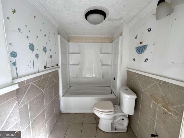 bathroom with toilet, tile walls, ornamental molding, and tile patterned flooring