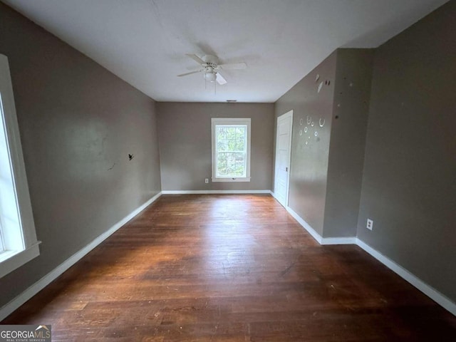 spare room with ceiling fan and dark hardwood / wood-style flooring