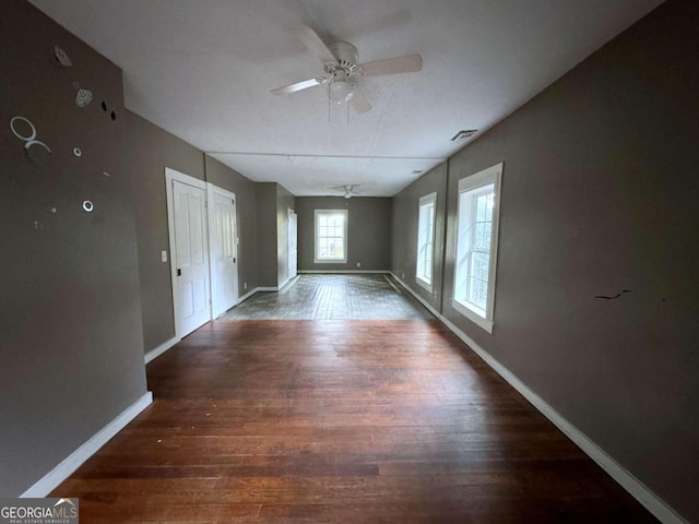 spare room with ceiling fan and dark hardwood / wood-style flooring