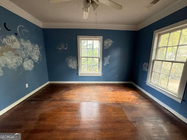 unfurnished room with ornamental molding, dark wood-type flooring, ceiling fan, and plenty of natural light