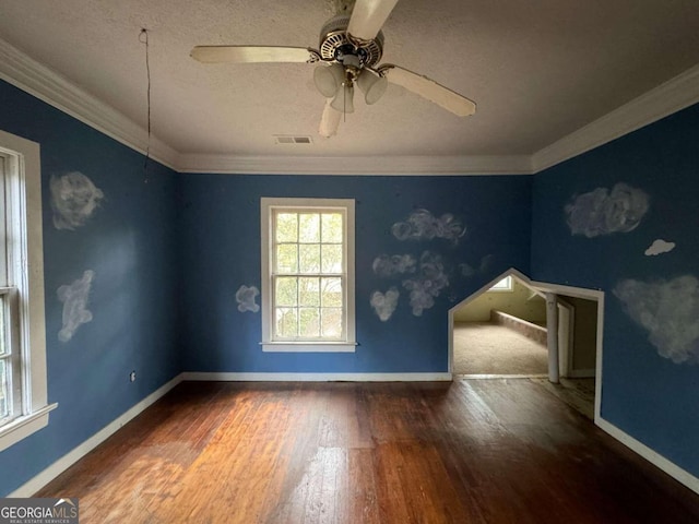 spare room featuring ornamental molding, a textured ceiling, wood-type flooring, and ceiling fan