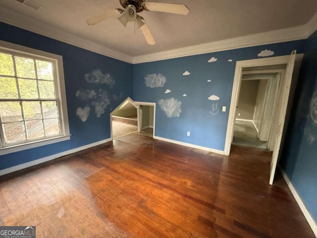 empty room featuring crown molding, dark hardwood / wood-style floors, and ceiling fan