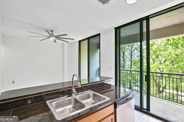 kitchen with sink, ceiling fan, stainless steel dishwasher, floor to ceiling windows, and light tile patterned floors