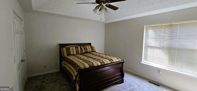 bedroom with light carpet, multiple windows, and ceiling fan