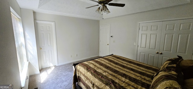 unfurnished bedroom featuring a textured ceiling, carpet floors, and ceiling fan