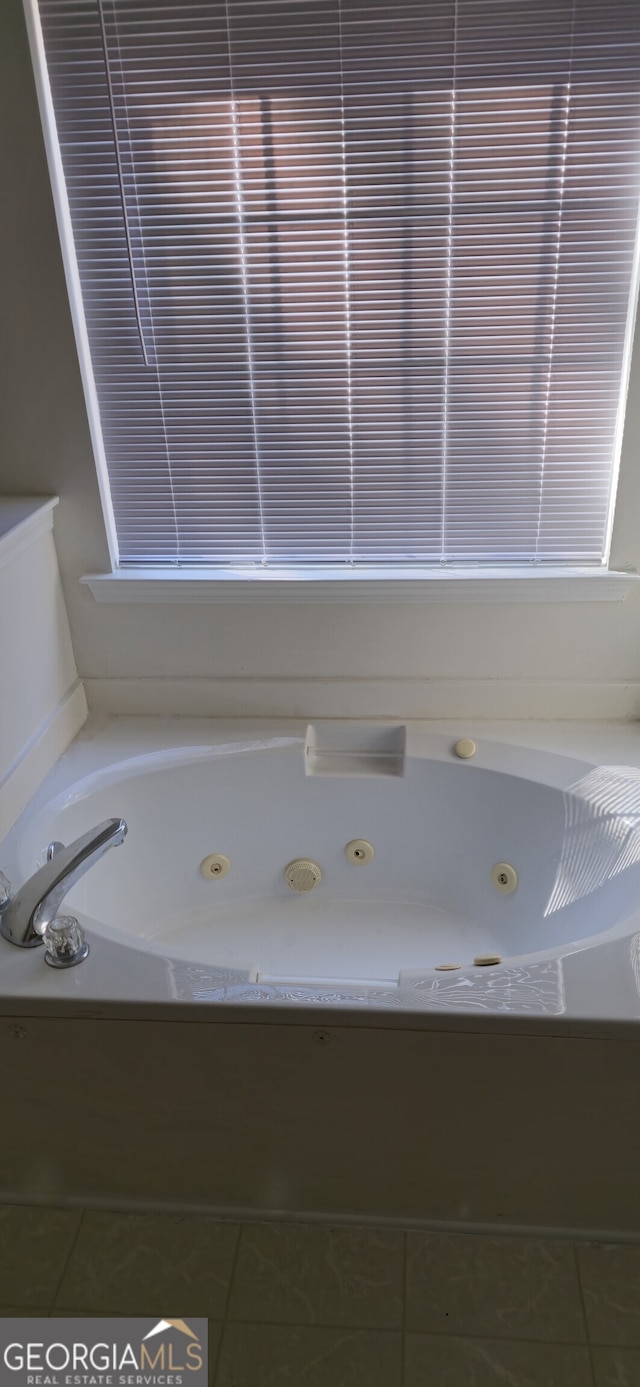 bathroom with a bathtub and tile patterned floors