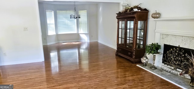 dining area with a high end fireplace and dark hardwood / wood-style flooring