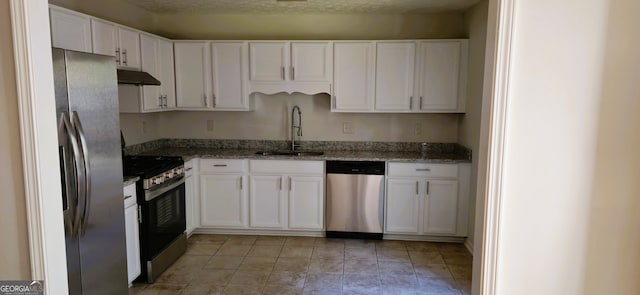 kitchen featuring stainless steel appliances, extractor fan, sink, and white cabinets